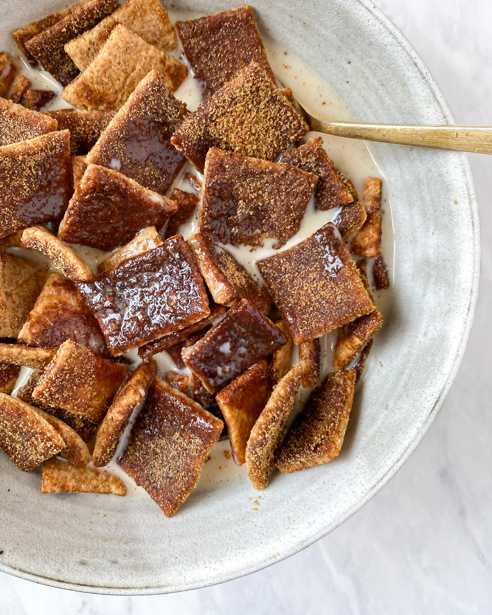 close up of healthy cinnamon toast crunch cereal in bowl with milk