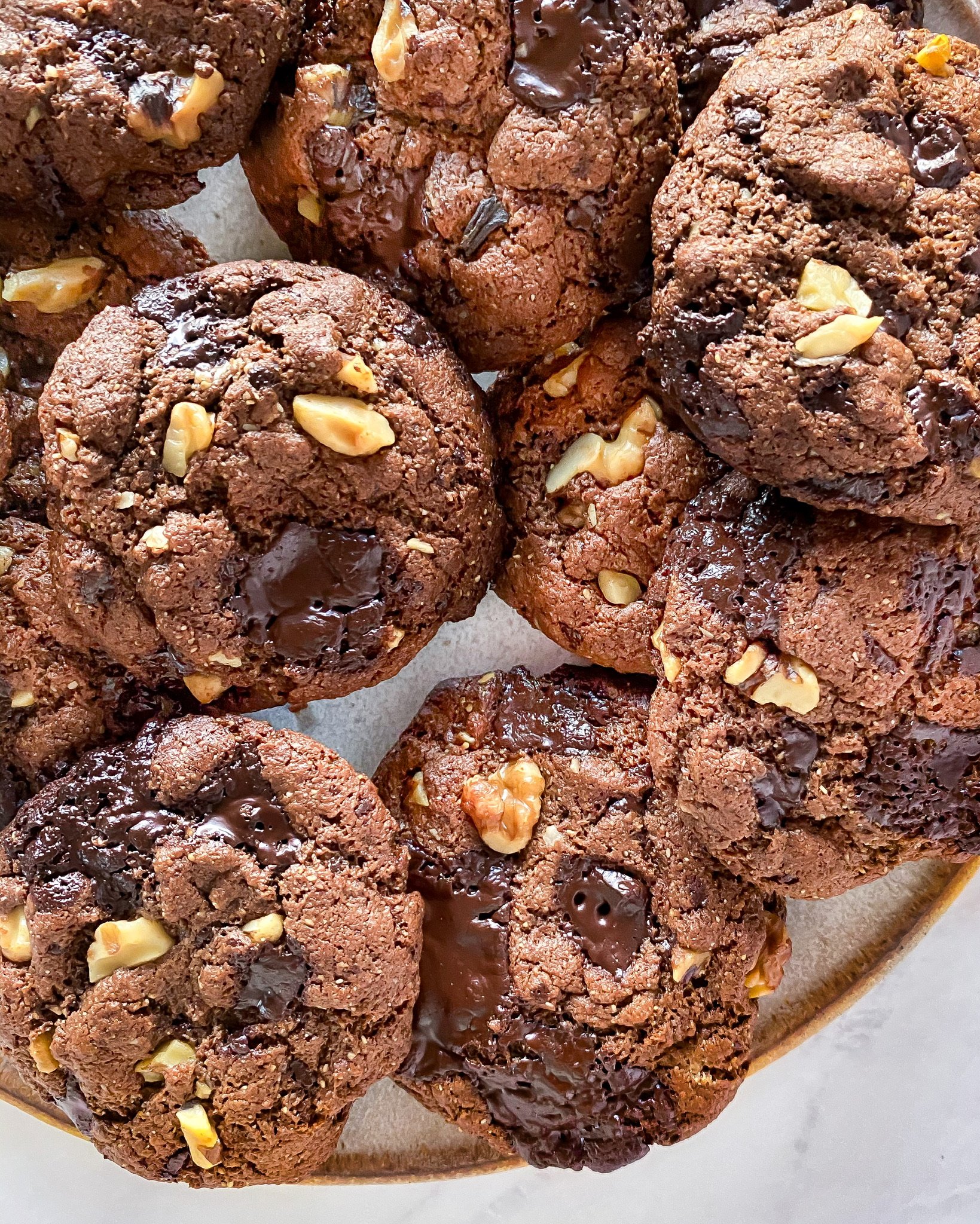 multiple healthy double chocolate chunk cookies together on a plate