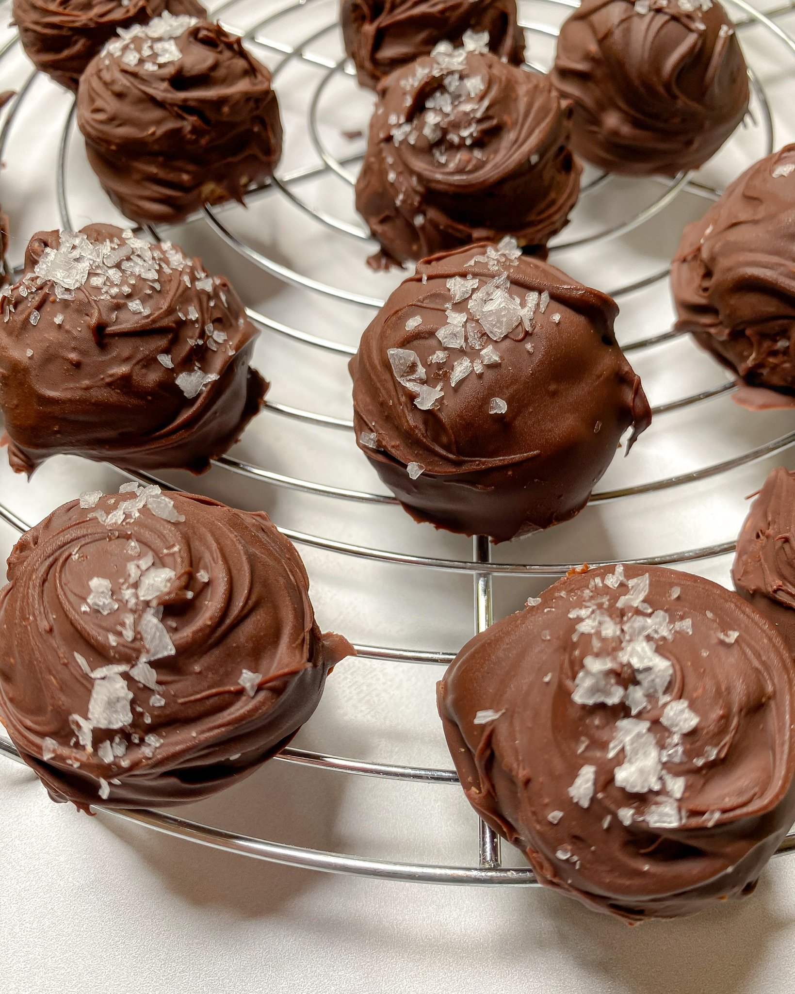 healthy brookie batter bites as chocolate dipped truffles on a baking sheet