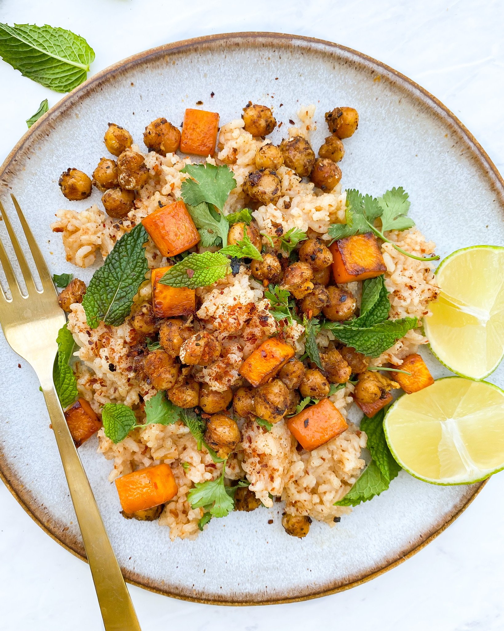 plated super herby harissa-spiced crispy chickpea rice with limes