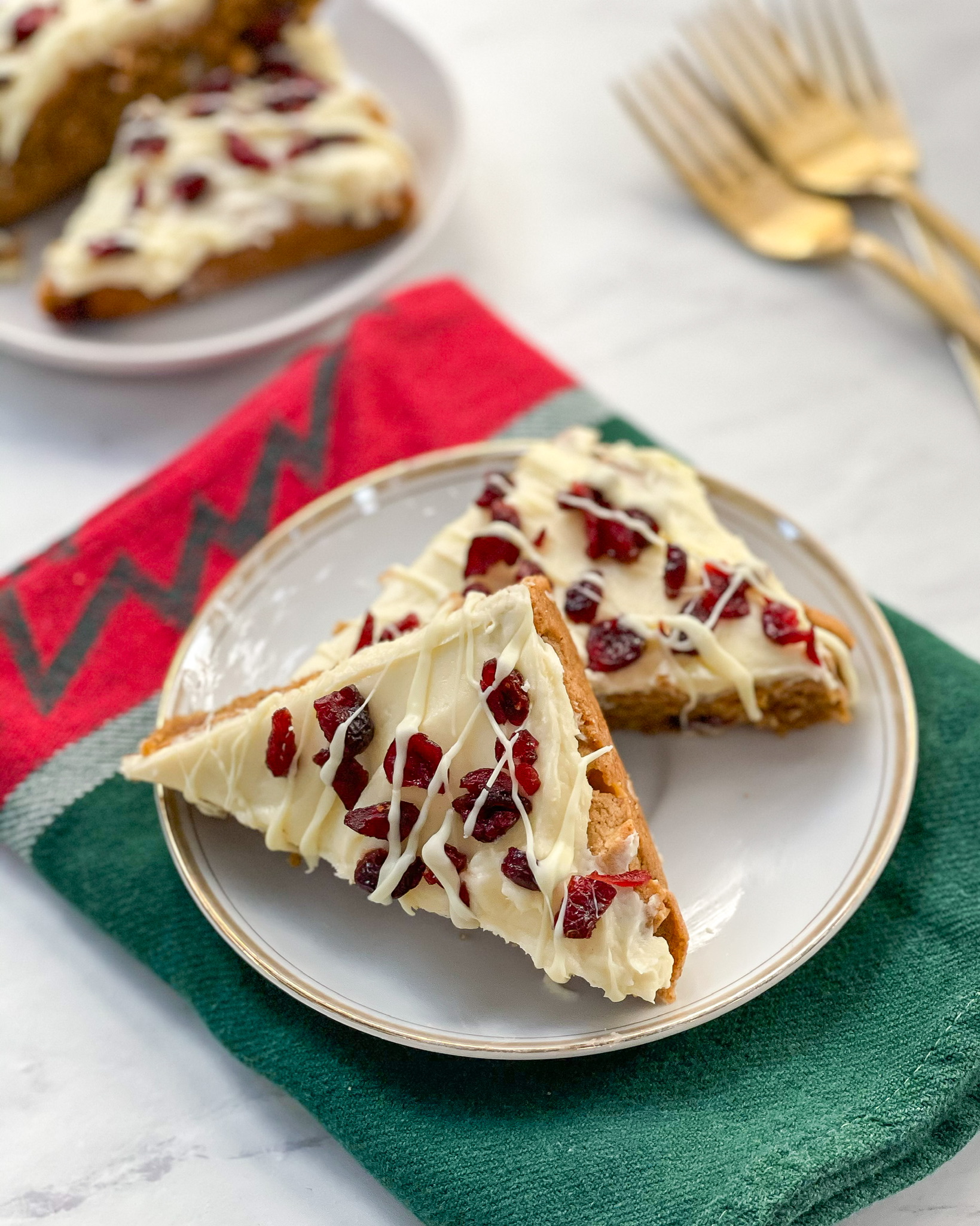 cranberry bliss bars on a plate side by side