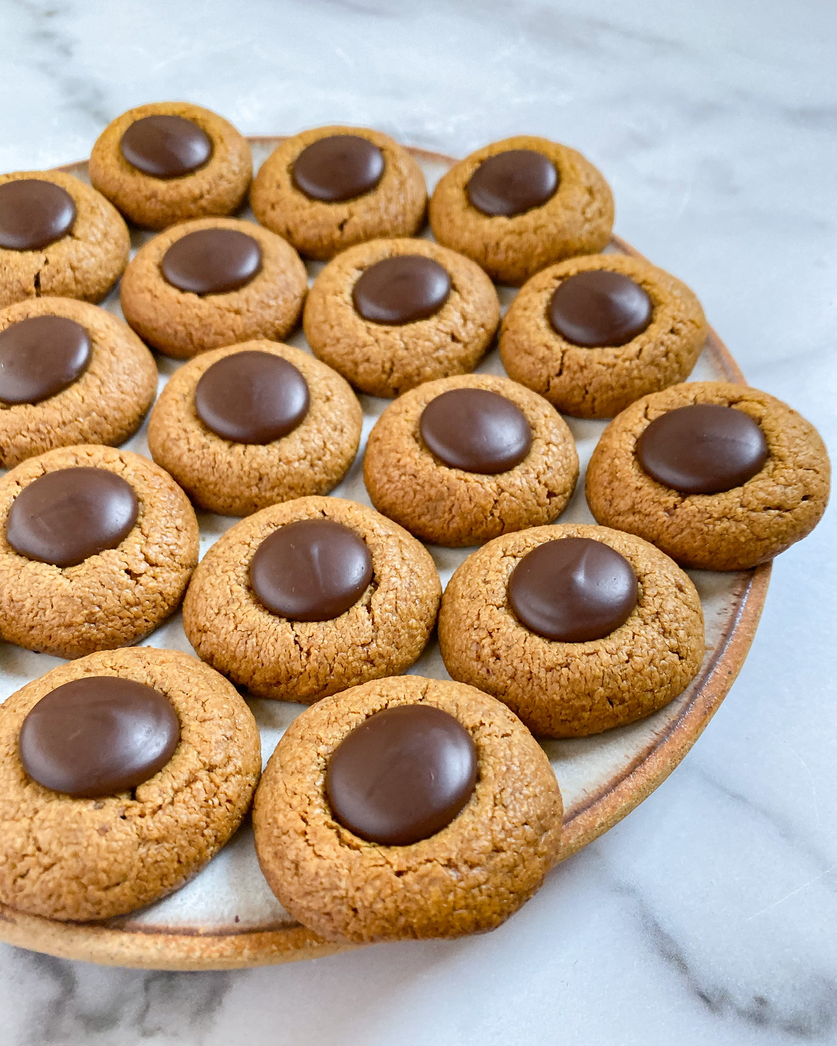 healthy peanut butter blossoms arranged on a platter